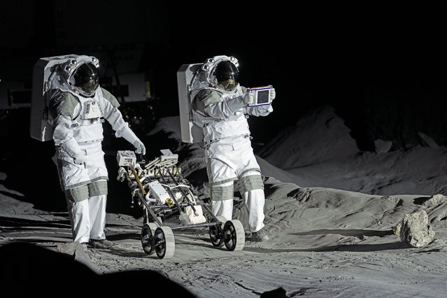 Astronauts Thomas Pesquet of France and Matthias Maurer of Germany demonstrate their training in lunar surface simulating conditions for future moon missions, like the Artemis lunar exploration program led by NASA, at the opening of the new LUNA facility at the European Astronaut Center in Cologne, Germany, Wednesday, September 25, 2024. (Photo by Martin Meissner/AP Photo)