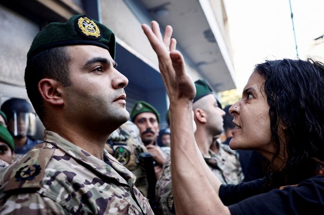 A woman reacts, as members of security forces attempt to evict displaced people from an old hotel, amid ongoing hostilities between Hezbollah and Israeli forces, in the Hamra neighborhood of Beirut, Lebanon, on October 21, 2024. (Photo by Yara Nardi/Reuters)