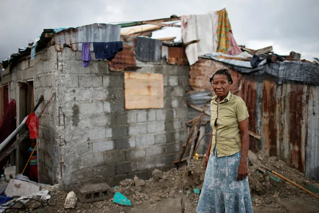 Rose Marie Michel, 64, poses for a photograph among the debris of her destroyed house after Hurricane Matthew hit Jeremie, Haiti, October 17, 2016. “My house was completely destroyed; no wall left standing, no traces of the roof or the things I had inside. I lost everything. I stayed with neighbours for a short time before moving to a shelter. I don't have anyone dead but right now I'm another Haitian homeless living in a shelter”, said Michel. (Photo by Carlos Garcia Rawlins/Reuters)