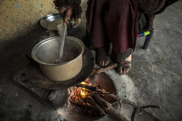 A girl cooks over a wood-burning fire at her house on Margalla Hills in Islamabad January 22, 2015. (Photo by Zohra Bensemra/Reuters)