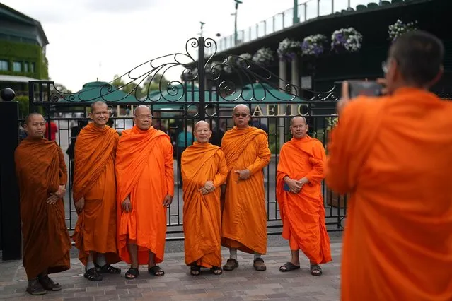 Buddhist monks pose for a photo outside the gates on day eleven of the 2023 Wimbledon Championships at the All England Lawn Tennis and Croquet Club in Wimbledon on Thursday, July 13, 2023. (Photo by Victoria Jones/PA Images via Getty Images)