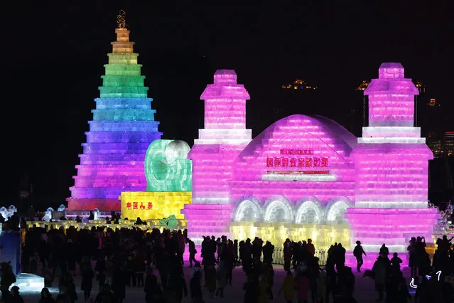 People visit the ice sculptures illuminated by coloured lights at Harbin ice and snow world during the opening ceremony of the 32nd Harbin International Ice and Snow Festival in Harbin city, China's northern Heilongjiang province, 05 January 2016. (Photo by Wu Hong/EPA)