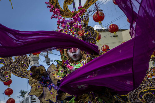  A participant performs during Grebeg Sudiro festival on February 15, 2015 in Solo City, Central Java, Indonesia. Grebeg Sudiro festival is held as a prelude to the Chinese New Year, which falls on February 19 this year, welcoming the Year of the Goat. People bring offerings known as gunungan, including Chinese sweetcakes piled up into the shape of mountains, which are paraded in the streets followed by Chinese and Javanese performers. (Photo by Ulet Ifansasti/Getty Images)