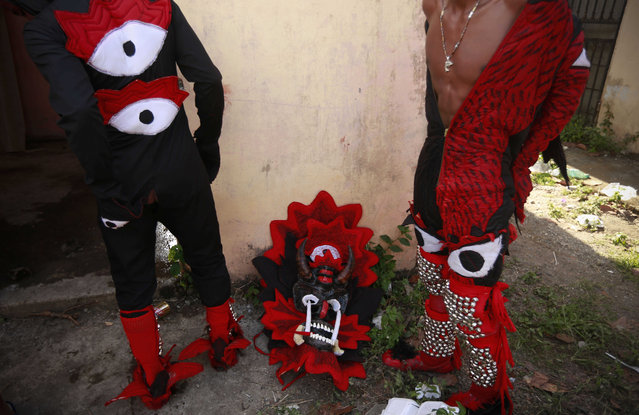 Two men prepare for the Devils and Congos carnival ritual, in Nombre de Dios, Panama, Wednesday, February 18, 2015. (Photo by Arnulfo Franco/AP Photo)