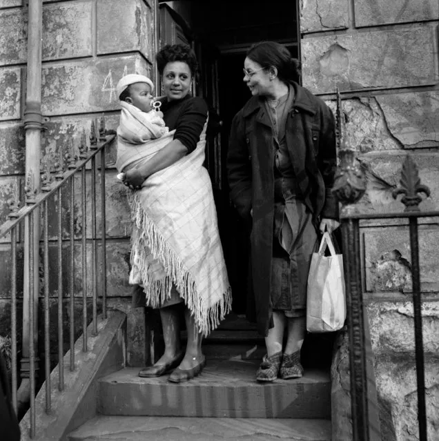 A couple of young women and a baby in Bute Town, one of the poorest areas of Cardiff, 23rd January 1954. The area has a lively ethnic mix of families with Arab, Somali, West African, West Indian, Egyptian, Greek, and many other origins. (Photo by Bert Hardy/Picture Post/Getty Images)