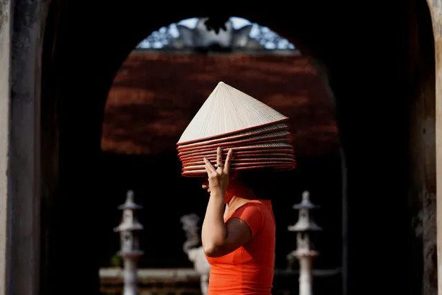 A woman sells traditional Vietnamese conical hats at Chuong village outside Hanoi in Vietnam September 19, 2018. (Photo by Reuters/Kham)