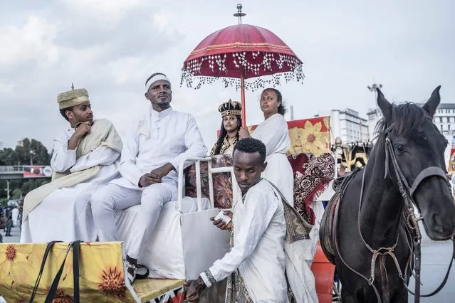 A group of youth dressed with royal costumes parade during the celebrations of the Ethiopian Orthodox holiday of Meskel in Addis Ababa on September 27, 2023. The Ethiopian Meskel celebration is an annual religious holiday in the Ethiopian Orthodox church that commemorates the discovery of the True Cross in the fourth century by the Roman Empress Helena. (Photo by Amanuel Sileshi/AFP Photo)