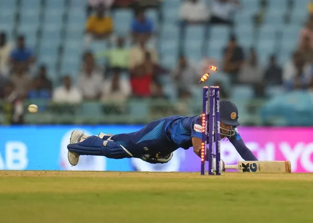 Sri Lanka's Dunith Wellalage dives unsuccessfully to run out by Australia's captain Pat Cummins during the ICC Men's Cricket World Cup match between Australia and Sri Lanka in Lucknow, India, Monday, October 16, 2023. (Photo by Aijaz Rahi/AP Photo)