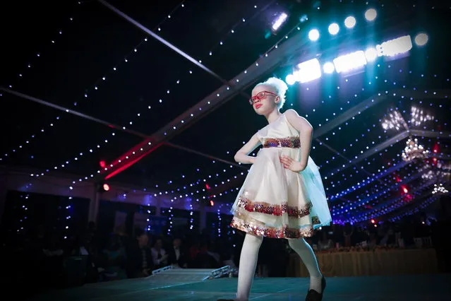 Shirlyne, a seven-year-old albino girl, takes to the catwalk during a fashion show held for the Mr. & Miss Albinism East Africa contest in Nairobi, Kenya, 30 November 2018. (Photo by Dai Kurokawa/EPA/EFE)