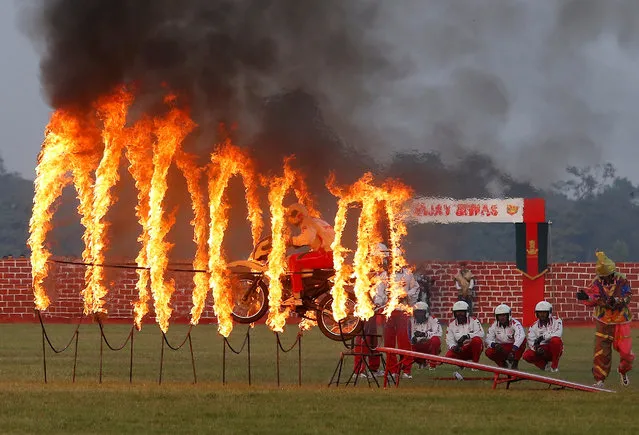 An Indian army soldier performs a stunt during celebrations ahead of the “Vijay Diwas”, a ceremony to celebrate the liberation of Bangladesh by the Indian Armed Forces on December 16 in 1971, in Kolkata, India, December 14, 2018. (Photo by Rupak De Chowdhuri/Reuters)