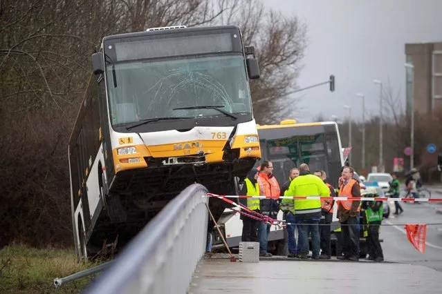 A Mainz Transport Company (BVG) public bus drove onto the railing of a highway overpass in an accident in Mainz, Germany, 10 February 2016. According to the fire department, three people slightly injured in the accident. (Photo by Fredrik von Erichsen/EPA)