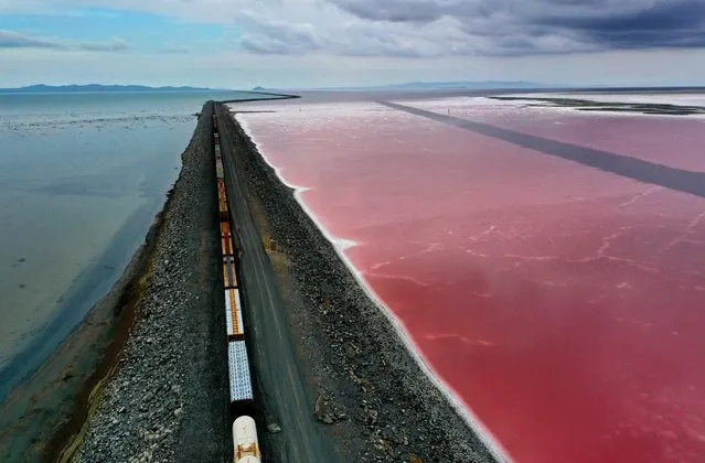 In an aerial view, a railroad causeway divides the Great Salt Lake on August 02, 2021 near Corinne, Utah. As severe drought continues to take hold in the western United States, water levels at the Great Salt Lake, the largest saltwater lake in the Western Hemisphere, have dropped to the lowest levels ever recorded. The lake fell below 4194.4 feet in the past week after years of decline from its highest level recorded in 1986 with 4211.65 feet. Further decline of the lake's water levels could result in an increase in water salinity and could generate dust from the exposed lakebed that could impact air quality in the area. The lake does not supply water or generate electricity for nearby communities but it does provide a natural habitat for migrating birds and other wildlife. According to the U.S. Drought Monitor, 99 percent of Utah is experiencing extreme drought conditions. (Photo by Justin Sullivan/Getty Images)