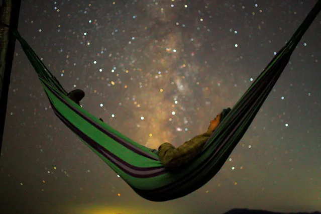 A girl lies in hammock as she looks at the milky way during the peak of Perseid meteor shower in Kozjak, Macedonia on August 13, 2018. (Photo by Ognen Teofilovski/Reuters)