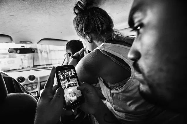 In this image released by World Press Photo titled “Citizen Journalism in Brazil's Favelas” by photographer Sebastian Liste for Noor agency which won third prize in the Daily Life Stories category shows the leader of the Papo Reto collective receiving an image of a 22-year-old taxi driver who was shot dead by a police officer, Rio de Janeiro, Brazil, Feb. 8, 2015. A group of friends from Alemao, a slum in Rio de Janeiro, formed a media collective called Papo Reto, or “straight talk”. Social media allow them to report stories from their community otherwise ignored by traditional media. (Photo by Sebastian Liste/Noor, World Press Photo via AP Photo)