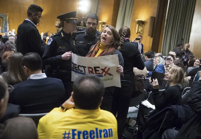 A protester is removed by Capitol Hill Police after shouting and disrupting the confirmation hearing for Secretary of State designate Rex Tillerson before the Senate Foreign Relations Committee, Wednesday, January 11, 2017, on Capitol Hill in Washington. (Photo by J. Scott Applewhite/AP Photo)