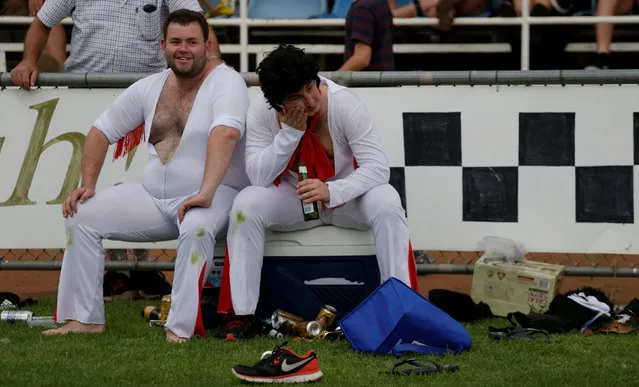 Players rest on the sideline with a beer as the Blue Suede Shoes and the Reddy Teddies amateur rugby teams play during the 25th annual Parkes Elvis Festival in the rural Australian town of Parkes, west of Sydney, Australia January 13, 2017. (Photo by Jason Reed/Reuters)