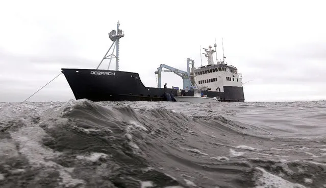 In this September 7, 2012 file photo, the research vessel Ocearch has set her anchor as the crew begins their search for great white sharks on the Atlantic Ocean, spending two to three weeks tagging sharks and collecting blood and tissue samples off the coast of Chatham, Mass. After tagging the sharks real-time satellite tracks the shark each time its dorsal fin breaks the surface, plotting its location on a map. Researchers in Massachusetts say great white sharks in the Atlantic Ocean are venturing offshore farther, with more frequency and at greater depths than previously known. The findings were published Sept. 29, 2017, in the scientific journal Marine Ecology Progress Series. (Photo by Stephan Savoia/AP Photo)
