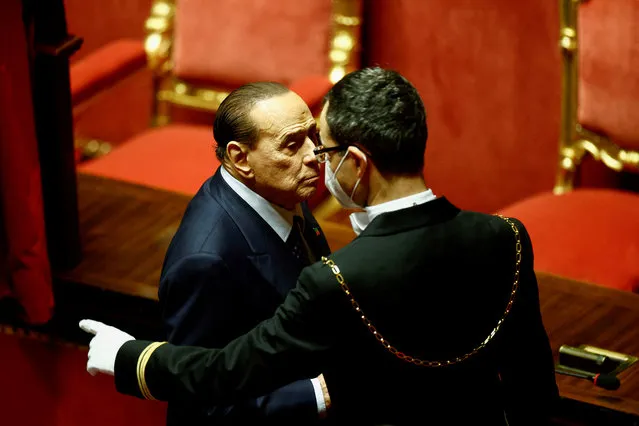 An usher indicates the correct way to exit the voting booth after Forza Italia leader and former Prime Minister Silvio Berlusconi cast his vote during the first voting session to elect the speaker of the Senate in Rome, Italy on October 13, 2022. (Photo by Yara Nardi/Reuters)