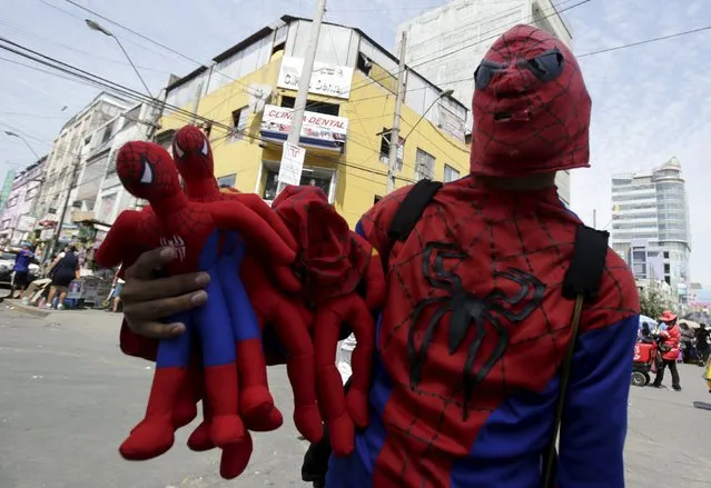 Fabian, wearing a Spider-Man costume, sells toys in the commercial zone of Gamarra in Lima, April 16, 2015. Gamarra, located in the central district of La Victoria, is home to the largest textile industry in Lima and has several shops and malls where all kinds of clothing are made. There are more than 10,000 entrepreneurs and 17,000 stores housed in the 20 blocks in the district, according to local media. (Photo by Mariana Bazo/Reuters)