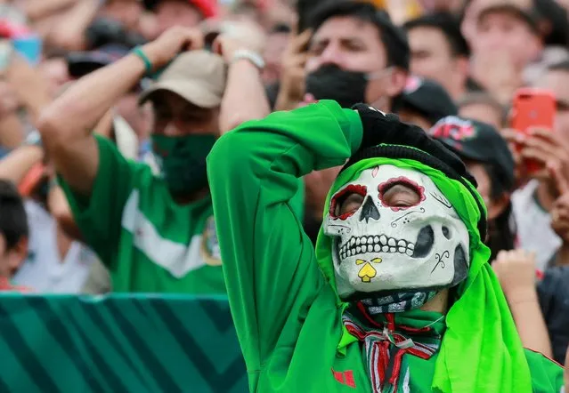A Mexico fan wearing a mask reacts in Mexico City during the Saudi Arabia v Mexico match on November 30, 2022. (Photo by Henry Romero/Reuters)