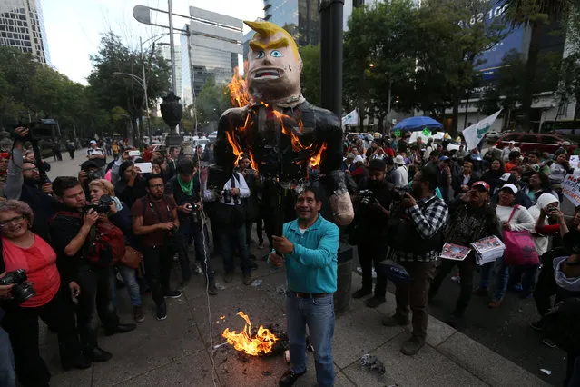 Demonstrators burn a pinata representing the U.S. President Donald Trump during a protest outside the U.S. embassy, in Mexico City, Mexico January 20, 2017. (Photo by Edgard Garrido/Reuters)