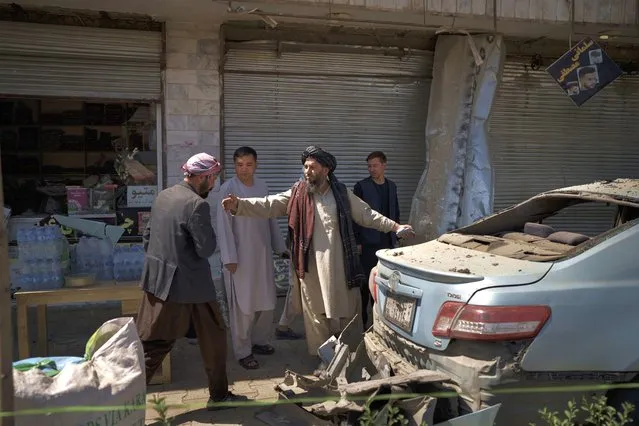 Taliban fighters and residents gather at the site of an explosion in Kabul, Afghanistan, Saturday, September 18, 2021. A sticky bomb exploded in the capital Kabul wounding a few people, said police officials. (Photo by Felipe Dana/AP Photo)