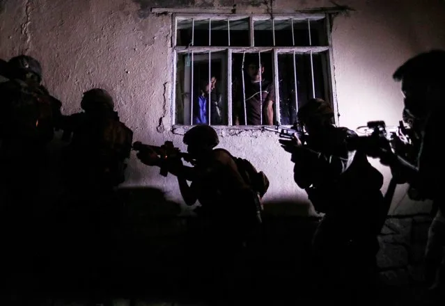 Turkish SWAT members starting an operation to stop the human trafficking and raid the houses used by the smugglers as secret houses in the​ border city of Van, Turkey, 25 August 2021. (Photo by Sedat Suna/EPA/EFE)