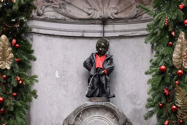 A picture shows the Manneken Pis statue dressed in tribute to late French-Belgian singer Johnny Hallyday on the fifth anniversary of his death in Brussels on December 5, 2022. (Photo by Kenzo Tribouillard/AFP Photo)