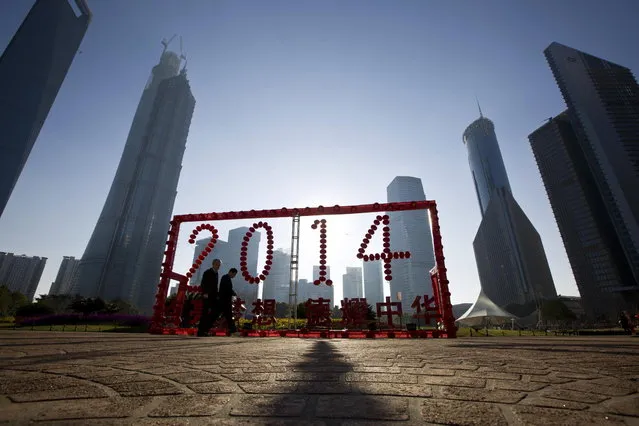People walk past a 2014 installation at Lujiazui financial district of Pudong ahead of the Chinese lunar New Year in Shanghai, January 23, 2014. (Photo by Aly Song/Reuters)