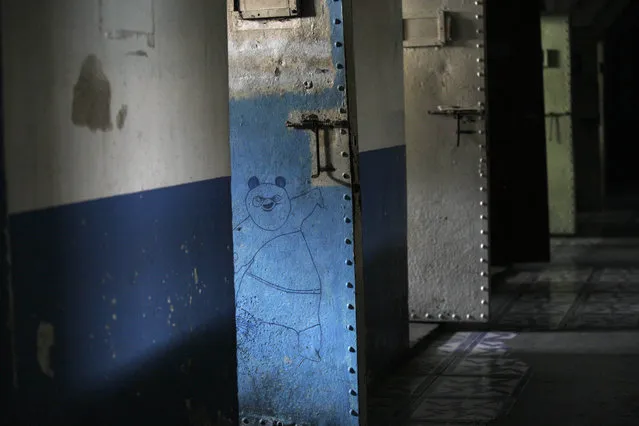 This April 7, 2015 photo shows a drawing of Po, the character from the Kung Fu Panda animated film, drawn on the door of a cell inside the now empty Garcia Moreno Prison, during a guided tour for the public in Quito, Ecuador. Now that this former world has been moved to another place, the time will soon come to erase the stories engraved on these walls. (Photo by Dolores Ochoa/AP Photo)