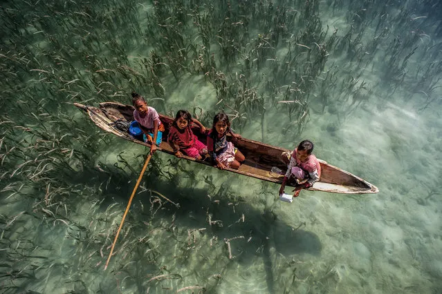 The Bajau people of Malaysia live their lives completely at sea, living in wooden huts and spending their days fishing. Sailing over crystal clear waters, the Bajau people of Malaysia live their lives almost entirely at sea. Children as young as four catch fish, octopus and lobsters from handmade boats off the eastern coast of Sabah, Malaysia. (Photo by Ng Choo Kia/Hotspot Media/SIPA Press)