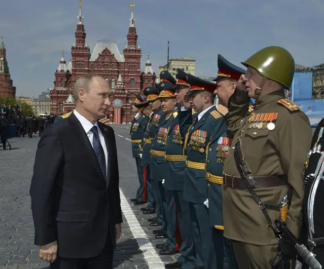 Russia's President Vladimir Putin (L) greets the commanders of units, participants of the Victory Day parade at Red Square in Moscow, Russia, May 9, 2015. (Photo by Reuters/Host Photo Agency/RIA Novosti)