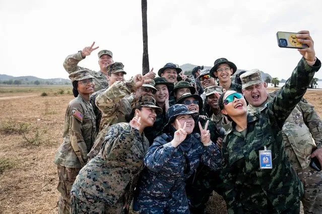 Various members of militaries from around the world take a selfie together as over 1500 military personnel representing Thailand, the United States of America, and South Korea participate in the 'Amphibious Exercise' as a part of Cobra Gold 2024, at Hat Yao Beach in Chonburi, Thailand, on March 1, 2024. (Photo by Matt Hunt/Anadolu via Getty Images)