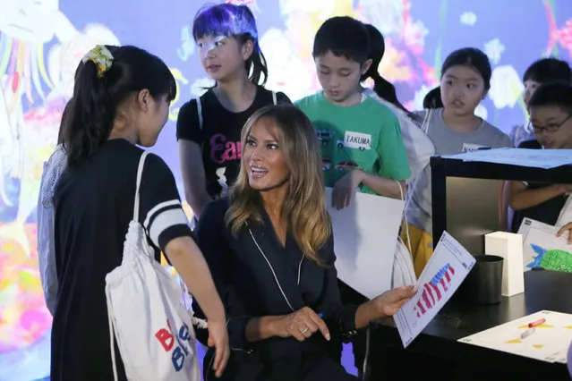 U.S. first lady Melania Trump chats with children as she visits a digital art museum Sunday, May 26, 2019, in Tokyo. (Photo by Koji Sasahara/AP Photo)