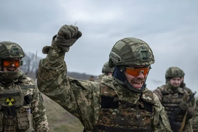 New recruits of the 1st Da Vinci Wolves Separate Mechanized Battalion, named after Dmytro Kotsiubailo, attend a military exercise in an undisclosed location, in Central Ukraine on March 12, 2024. (Photo by Viacheslav Ratynskyi/Reuters)