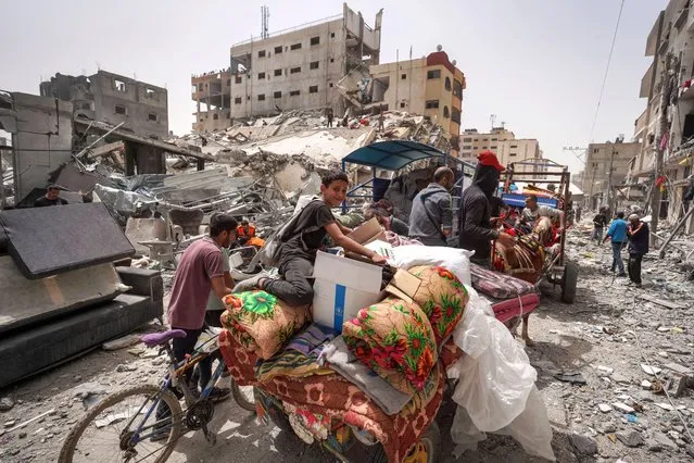 Palestinians pack their belongings in a truck as they leave their home in the city of Nuseirat in the central Gaza Strip on April 18, 2024, amid ongoing battles between Israel and the militant Hamas group. (Photo by AFP Photo/Stringer)