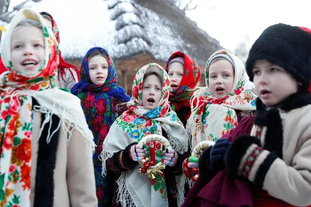 Children dressed in traditional costumes sing Christmas carols as they gather to celebrate Orthodox Christmas at a compound of the National Architecture museum in Kyiv, Ukraine on January 7, 2022. (Photo by Valentyn Ogirenko/Reuters)