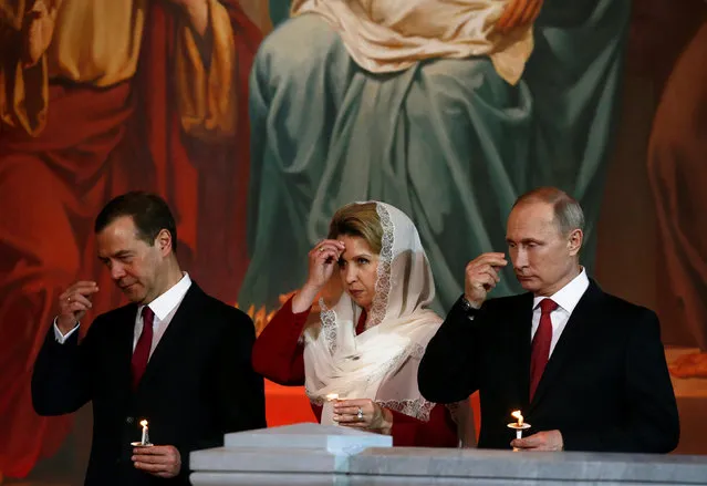 Russian President Vladimir Putin (R), Prime Minister Dmitry Medvedev and his wife Svetlana, pray during an Orthodox Easter service at the Christ the Saviour Cathedral in Moscow, Russia, May 1, 2016. (Photo by Sergei Karpukhin/Reuters)