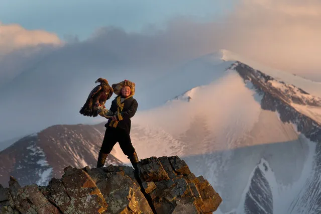 13 year old Ashol Pan with her eagle – Despite her young age, Ashol had the amazing ability to control and be able to caress her eagle, almost as if she had been with it for years. (Photo by Asher Svidensky/Caters News)