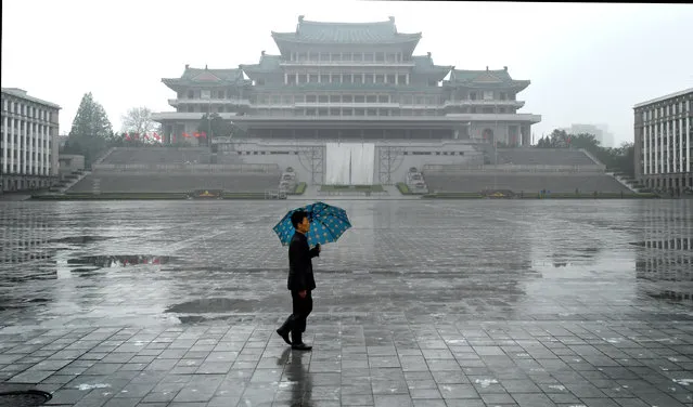 A man walks by the Grand People's Study House in Pyongyang, North Korea on May 6, 2016. The central library was constructed in a traditional Korean style in April 1982 over a period of 21 months to celebrate leader Kim Il-sung's 70th birthday. (Photo by Linda Davidson/The Washington Post)