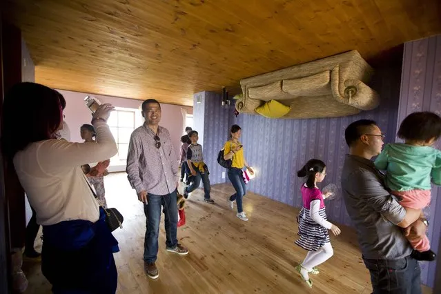 Tourists visit at an upside-down house at Fengjing Ancient Town, Jinshan District, south of Shanghai, May 1, 2014. (Photo by Aly Song/Reuters)