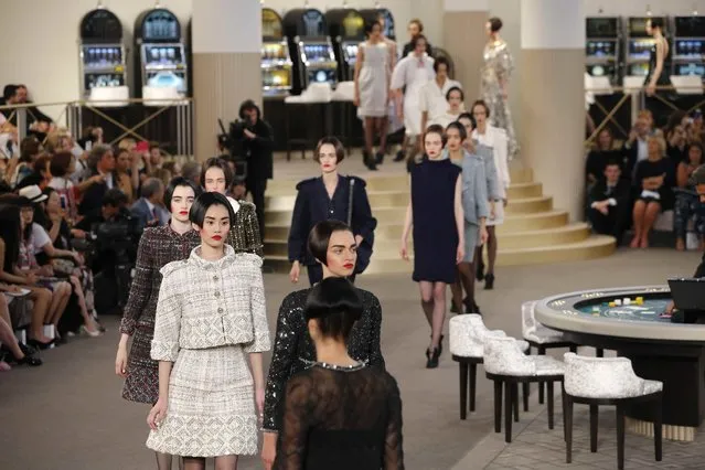 Models present creations by German designer Karl Lagerfeld as part of his Haute Couture Fall Winter 2015/2016 fashion show for French fashion house Chanel at the Grand Palais which is transformed into a casino in Paris, France, July 7, 2015. (Photo by Stephane Mahe/Reuters)