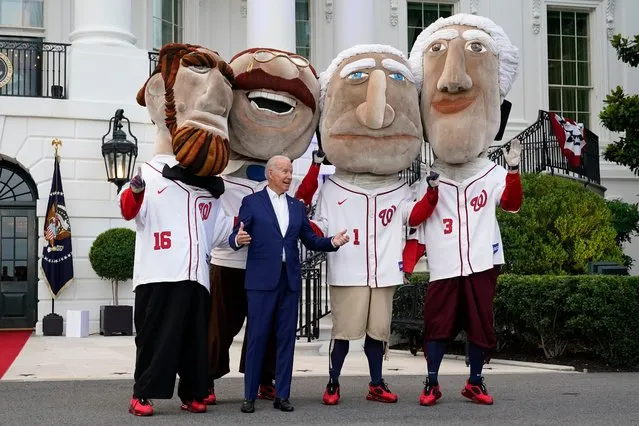 President Joe Biden visits with members of the Washington Nationals' Racing Presidents after speaking at an Independence Day celebration on the South Lawn of the White House, Sunday, July 4, 2021, in Washington. (Photo by Patrick Semansky/AP Photo)