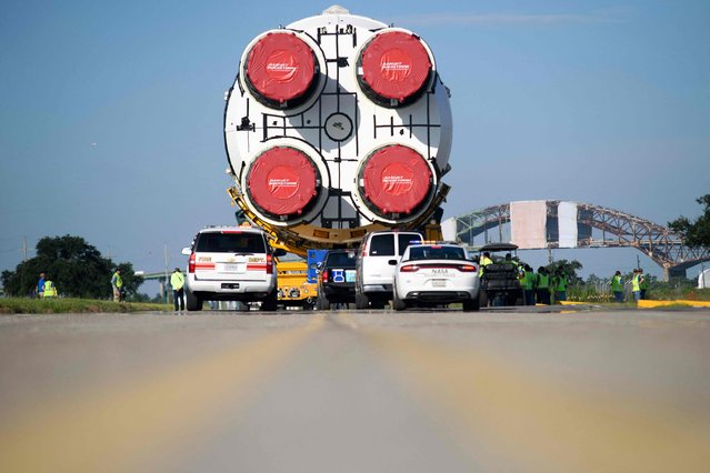 The Artemis II rocket core stage is wheeled out at the NASA Michoud Assembly Facility in New Orleans, Louisiana, on July 16, 2024. The stage will launch the first crewed Artemis mission. (Photo by Mark Felix/AFP Photo)