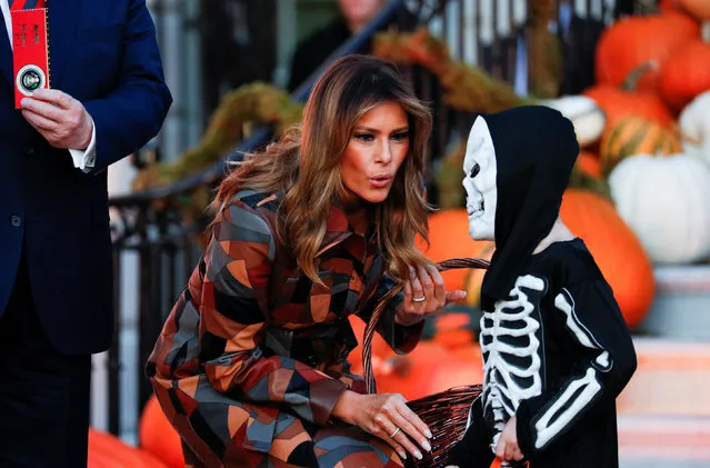 U.S. first lady Melania Trump reacts to a young trick-or-treater dressed as a skeleton as the first lady and the president hand out Halloween candy to visiting schoolchildren in advance of Halloween at the White House in Washington, U.S., October 28, 2019. (Photo by Tom Brenner/Reuters)