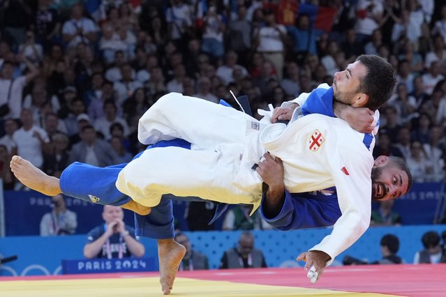 Georgia's Vazha Margvelashvili and France's Walide Khyar compete during their men -66 kg elimination round match in team judo competition at Champ-de-Mars Arena during the 2024 Summer Olympics, Sunday, July 28, 2024, in Paris, France. (Photo by Eugene Hoshiko/AP Photo)