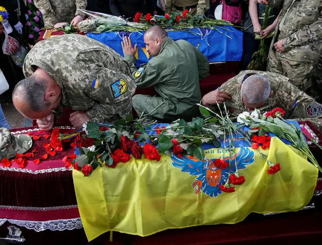 Servicemen take part in a funeral ceremony for Mykola Kuliba and Serhiy Baula, servicemen from the “Aydar” battalion, who were killed in the fighting in eastern Ukraine, at Independence Square in central Kiev, Ukraine May 26, 2016. (Photo by Gleb Garanich/Reuters)