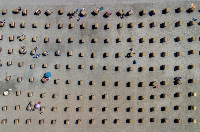 Hundreds of beach chairs decorate the beach at the Baltic Sea in Travemuende, Germany, Monday, July 15, 2024. Travemuende is one of the summer tourist hot spots in Germany. (Photo by Michael Probst/AP Photo)