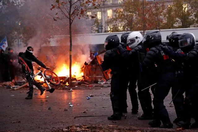 French CRS riot police face off with protesters during clashes at a demonstration against French government's pensions reform plans in Paris as part of a day of national strike and protests in France, December 5, 2019. (Photo by Gonzalo Fuentes/Reuters)