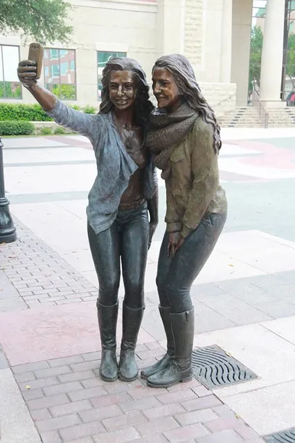 A statue depicts two girls posing for a selfie in the town square of Houston suburb Sugar Land, Texas, U.S. in an undated picture courtesy of the City of Sugar Land.  The statue, part of an installation of 10 works, sparked a torrent of criticism from those who saw it as an unpleasant surprise. (Photo by Reuters/City of Sugar Land)